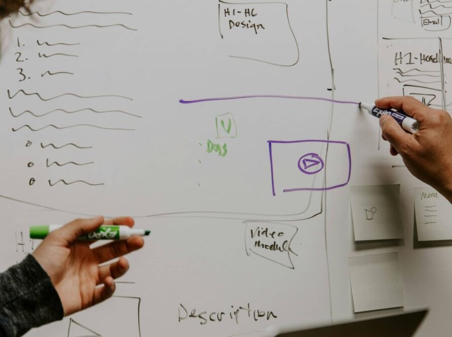People penning ideras on a storyboard, by Kaleidico on Unsplash